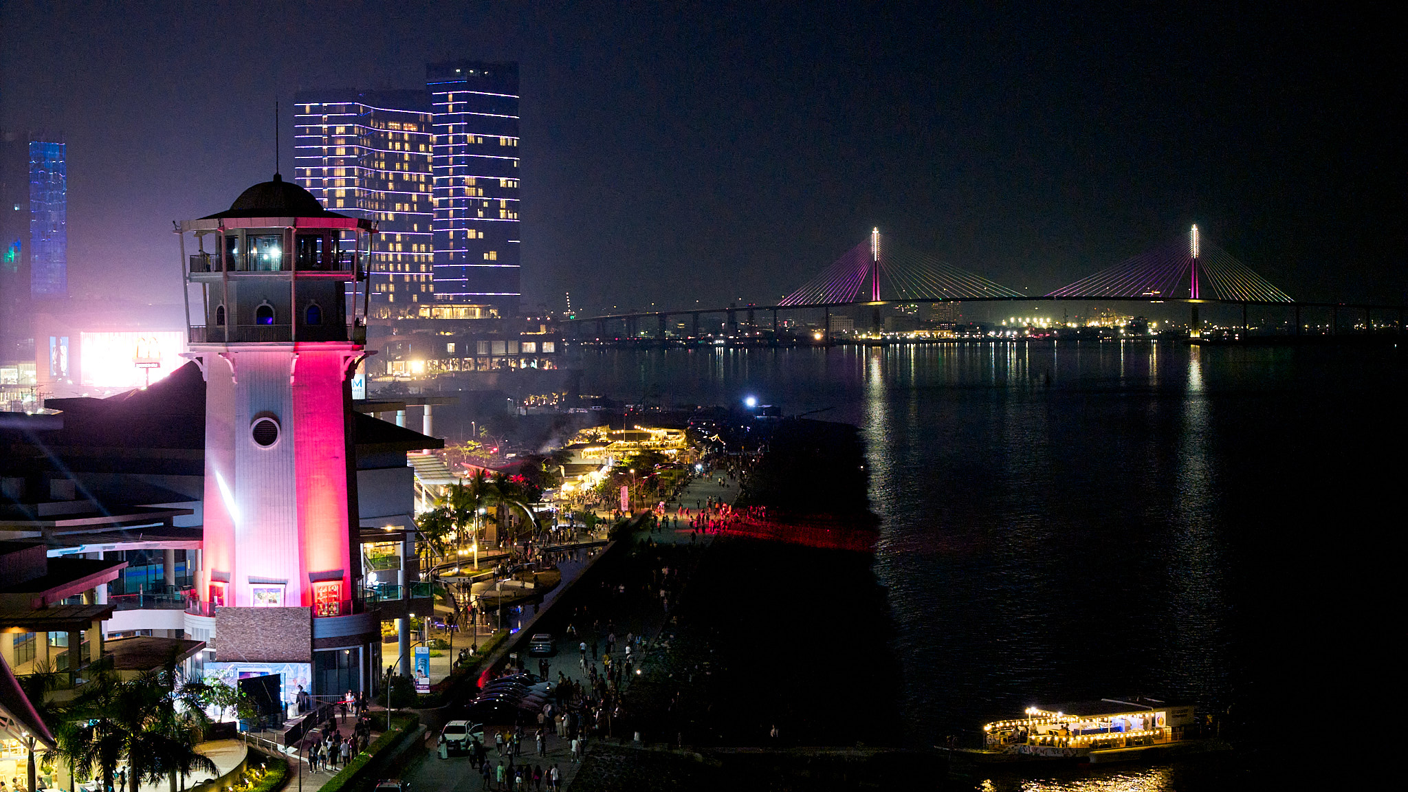 The Cebu Lighthouse at night with the Cebu-Cordova Bridge