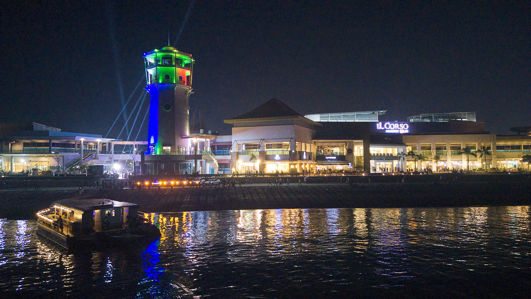 The lighthouse lit at night along the SRP waterfront